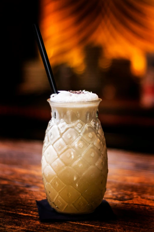 a drink in a glass with a straw and ice