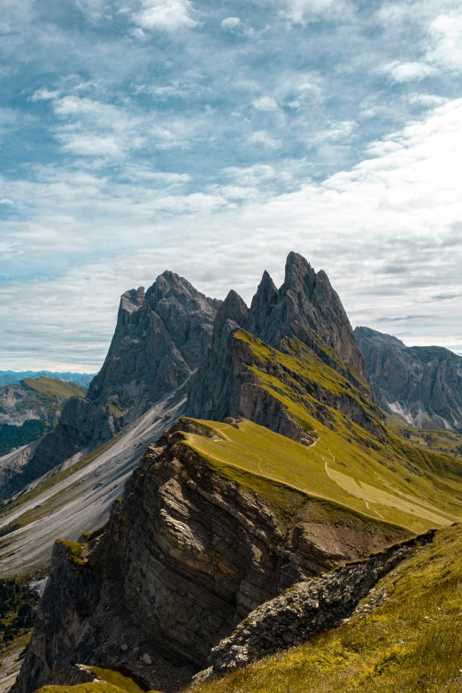 a mountain with lots of green grass below it