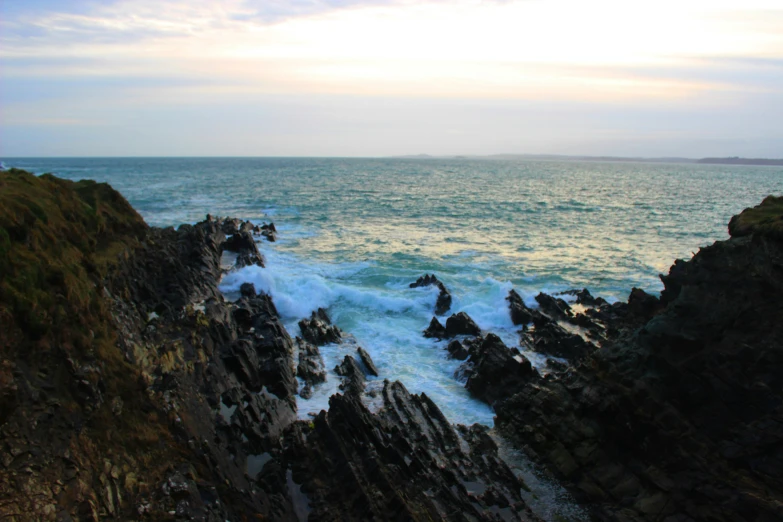 water splashing over rocks in the middle of the ocean