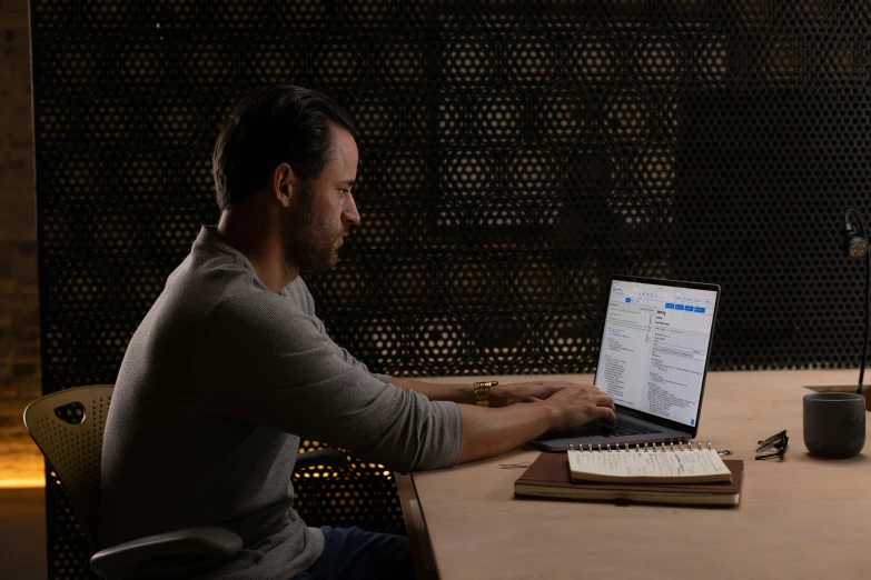 a man sitting at a desk with a computer