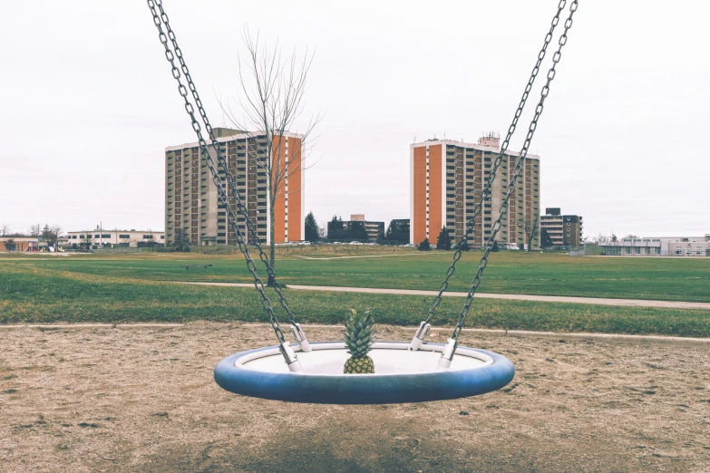 a park with two swings sitting next to each other