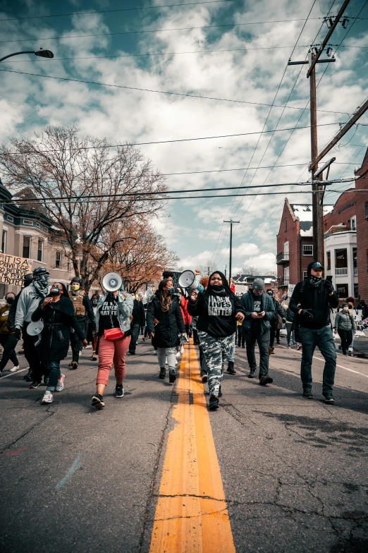 police and protesters walking down the street with their guns