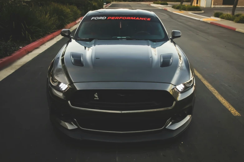 a close up of a sports car on the road