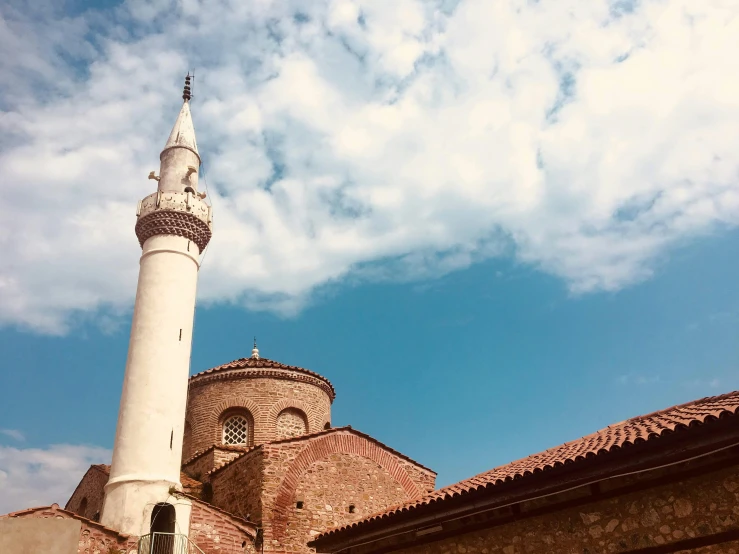 a tall tower in the background and a large building