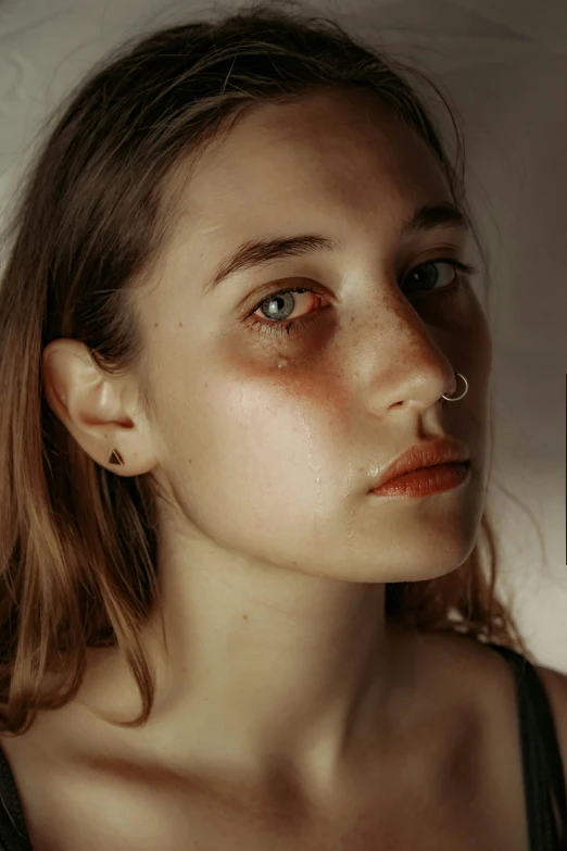 a close up of a girl wearing red lipstick and piercings