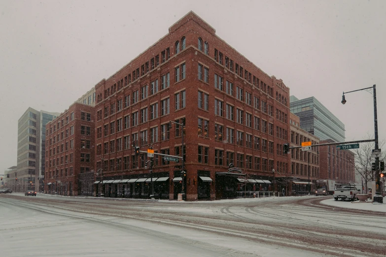 a large red building on a snowy city street