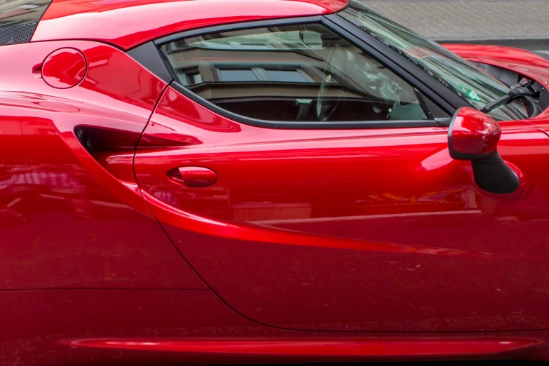 close up of a shiny red car with a white bird