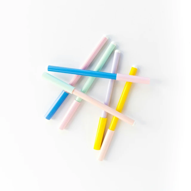 four multicolored toothbrushes are laying on top of each other