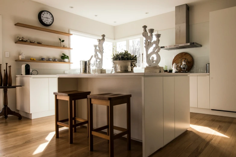 a kitchen with two stools and a center island