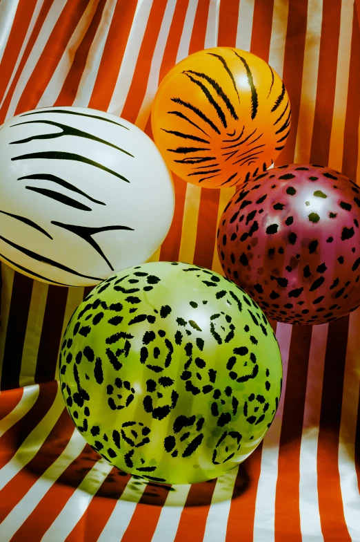 a close up of three balls with ze stripes