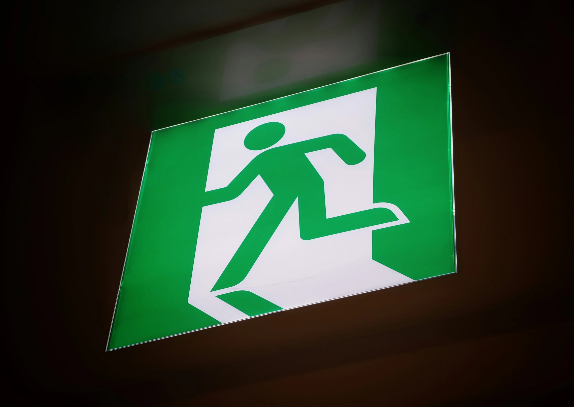 the sign has the man running to the emergency exit