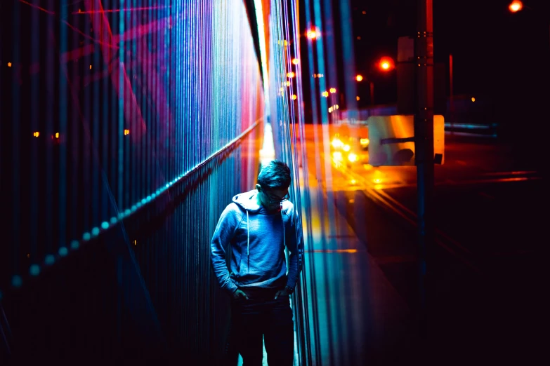 a woman walking down a street next to tall colorful poles