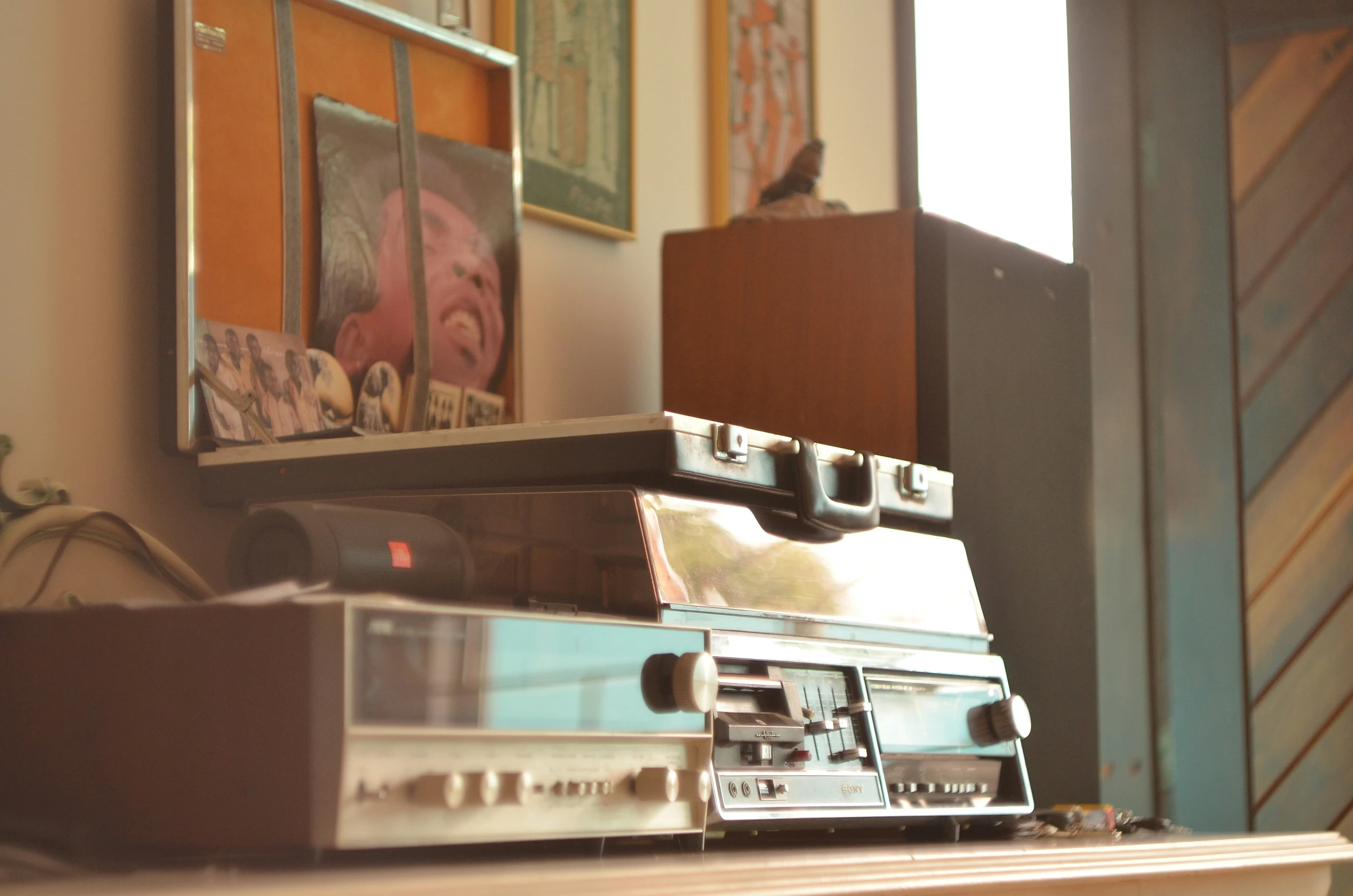 stacked silver radio sitting on top of a dresser