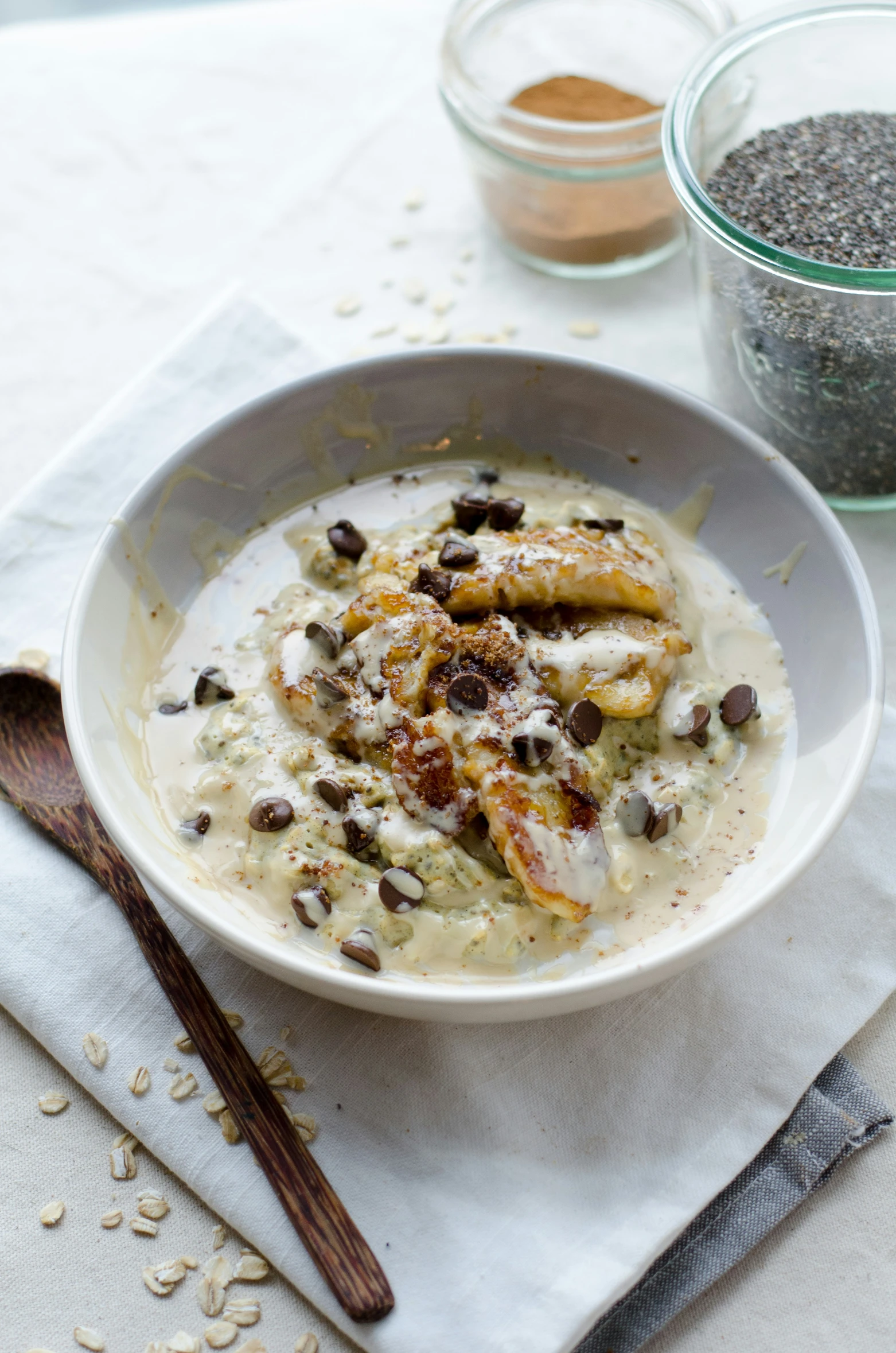 an oatmeal bowl containing a spoon and a spoon