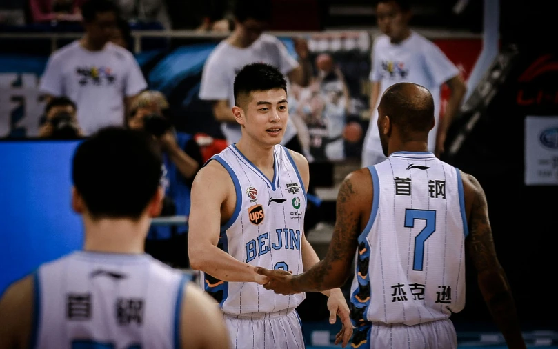 two basketball players and one is talking to each other