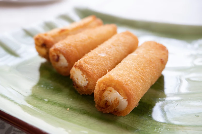 two cooked food item sitting on top of a green plate