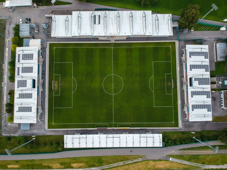 an aerial po of a stadium area and green soccer field