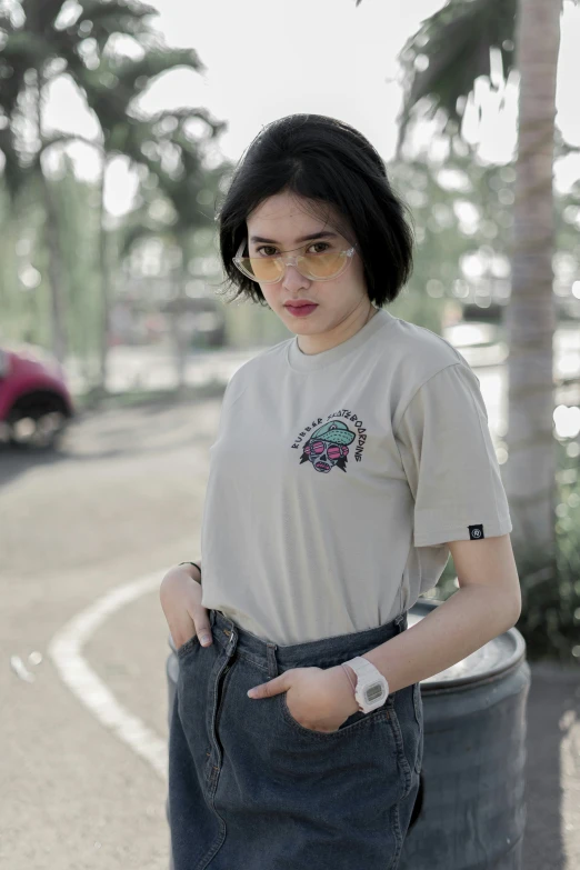 an asian girl in a cream shirt pointing to the side