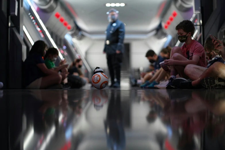 a man standing next to a ball inside of a hallway