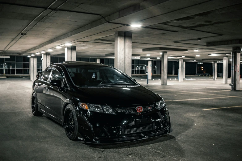 black car parked in a parking garage with no doors