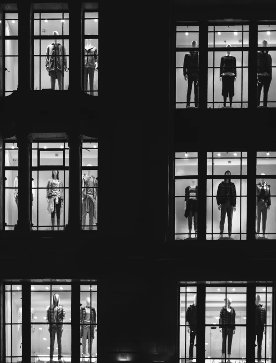 people looking out windows at a building that has multiple stories with only one story on each