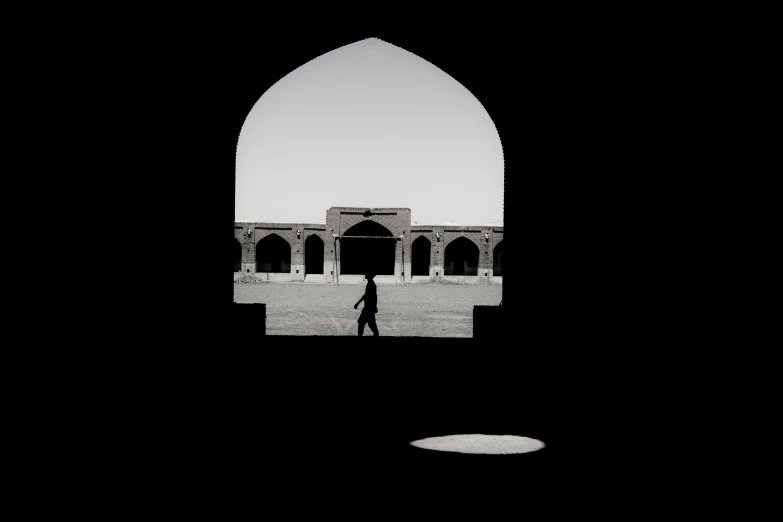 silhouetted silhouettes of people walking around a courtyard