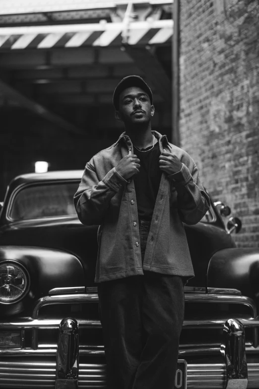 a man standing next to his old classic car