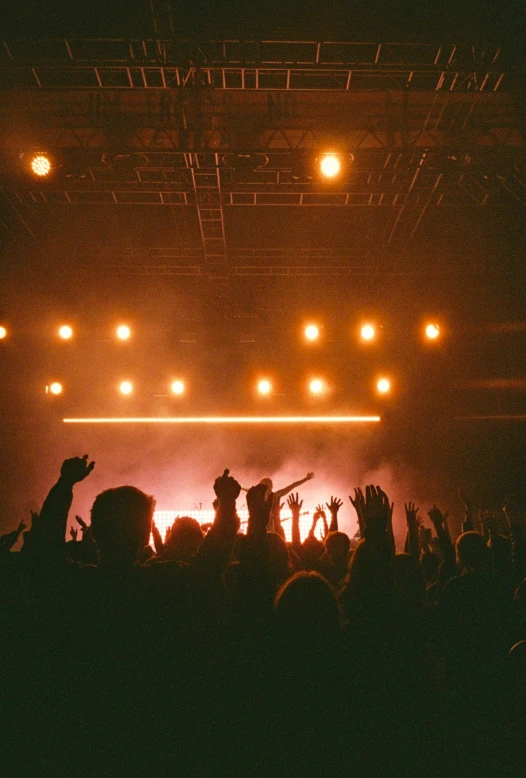 an audience is watching a concert at night