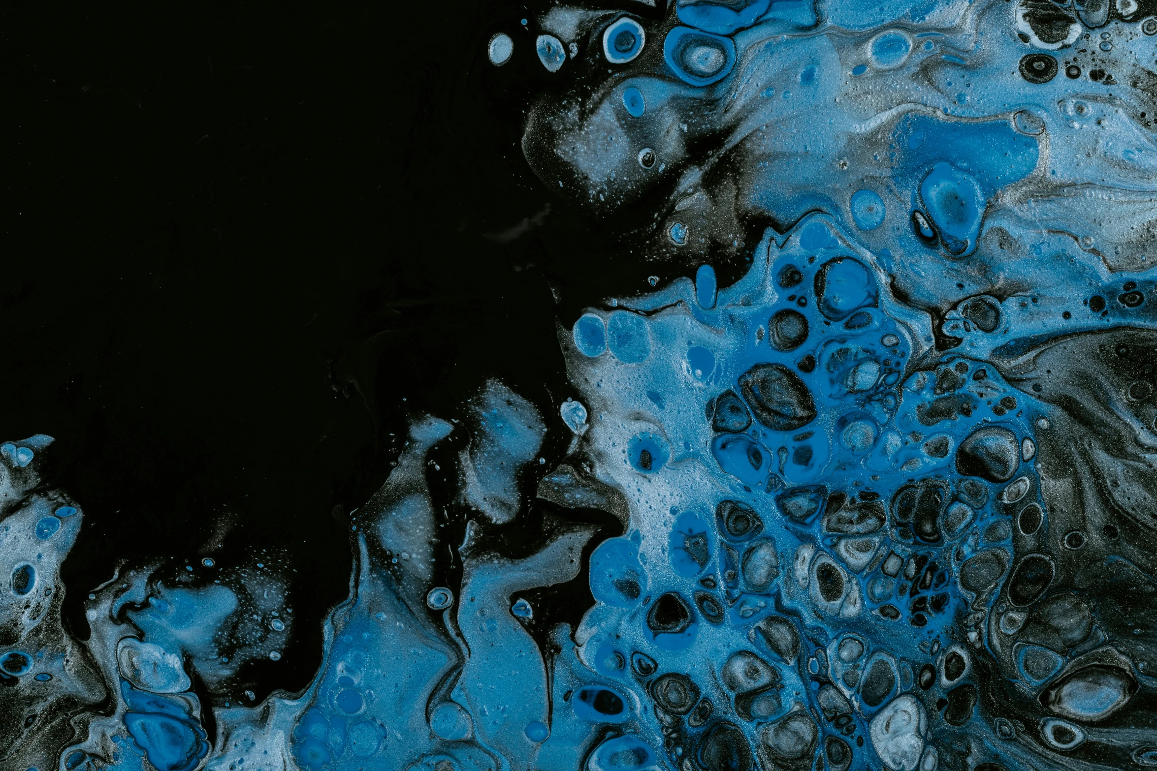 a fluid painting with dark blue, black and white tones