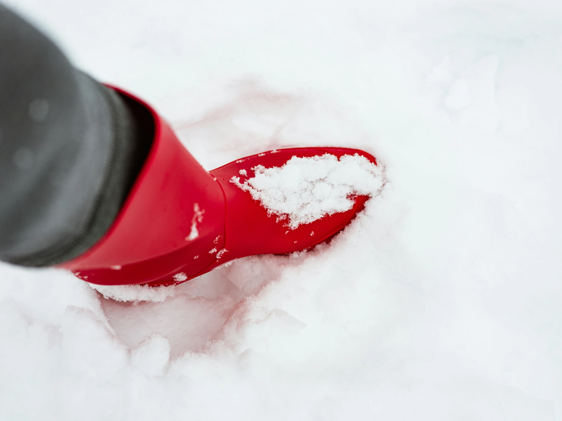 a red boot with snow on top of it
