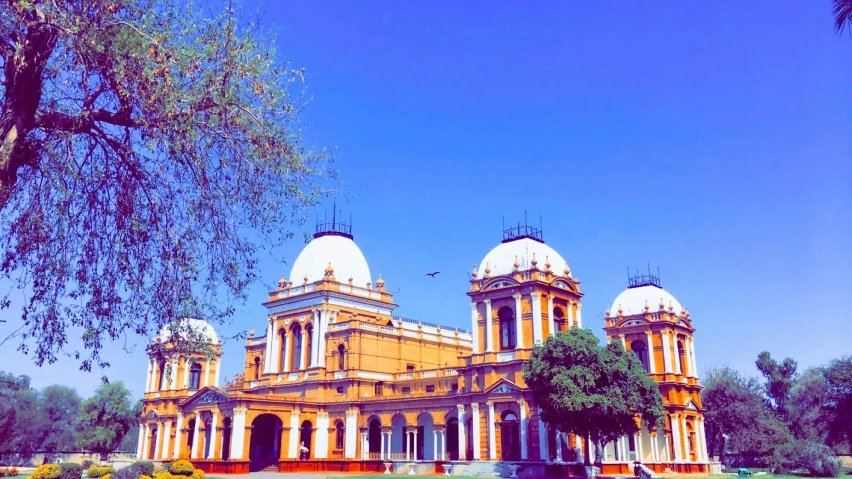 a large building with a lot of trees in front