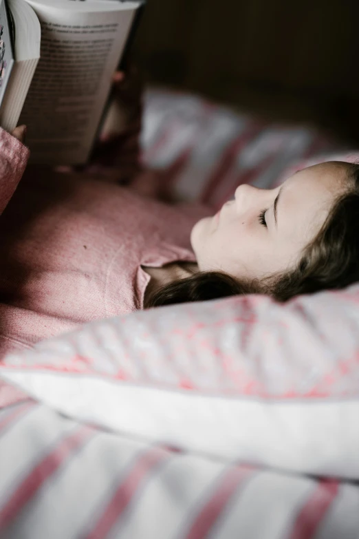 a  reading a book in bed