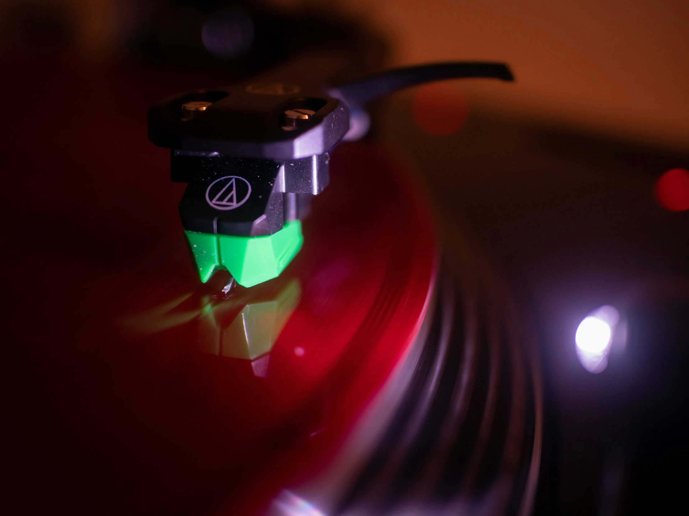 a red and green object with a black light around it