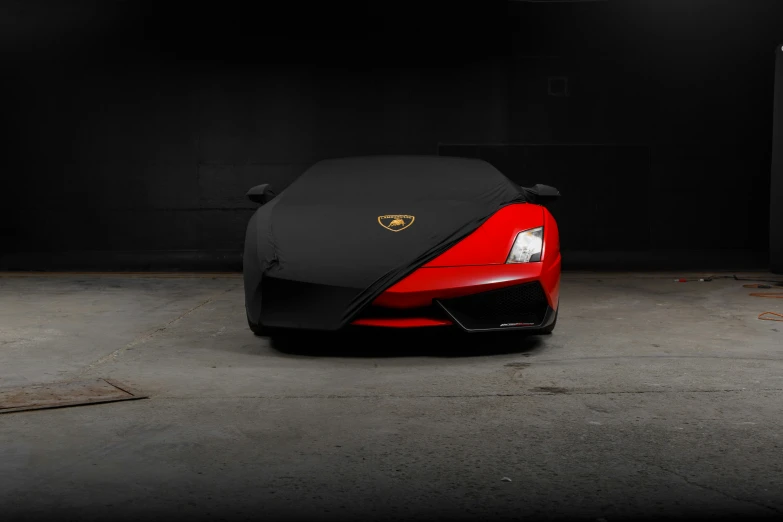 a red ferrari parked in front of a garage