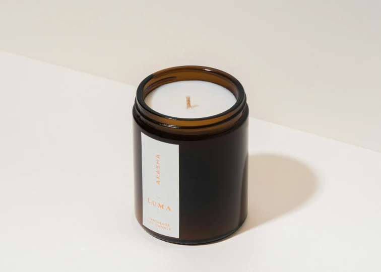 a brown candle sitting on top of a white counter