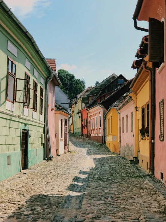 old - fashioned houses are lined up against the brick sidewalk