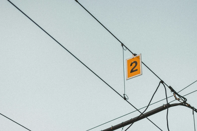 a square sign attached to a wooden pole