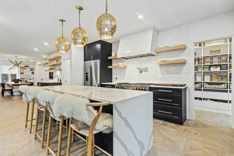 the kitchen is well organized and has marble island top