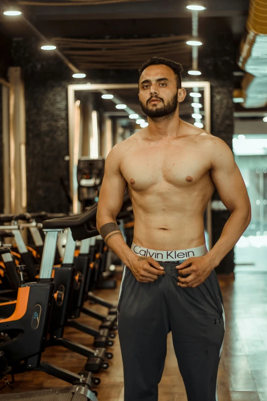 a man standing in a gym while looking off to the side