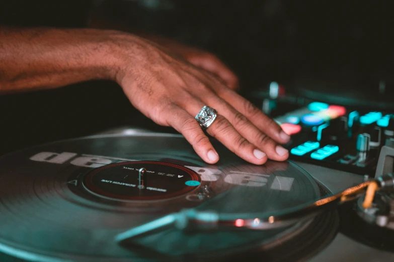 a close up of a dj spinning some records on a turntable
