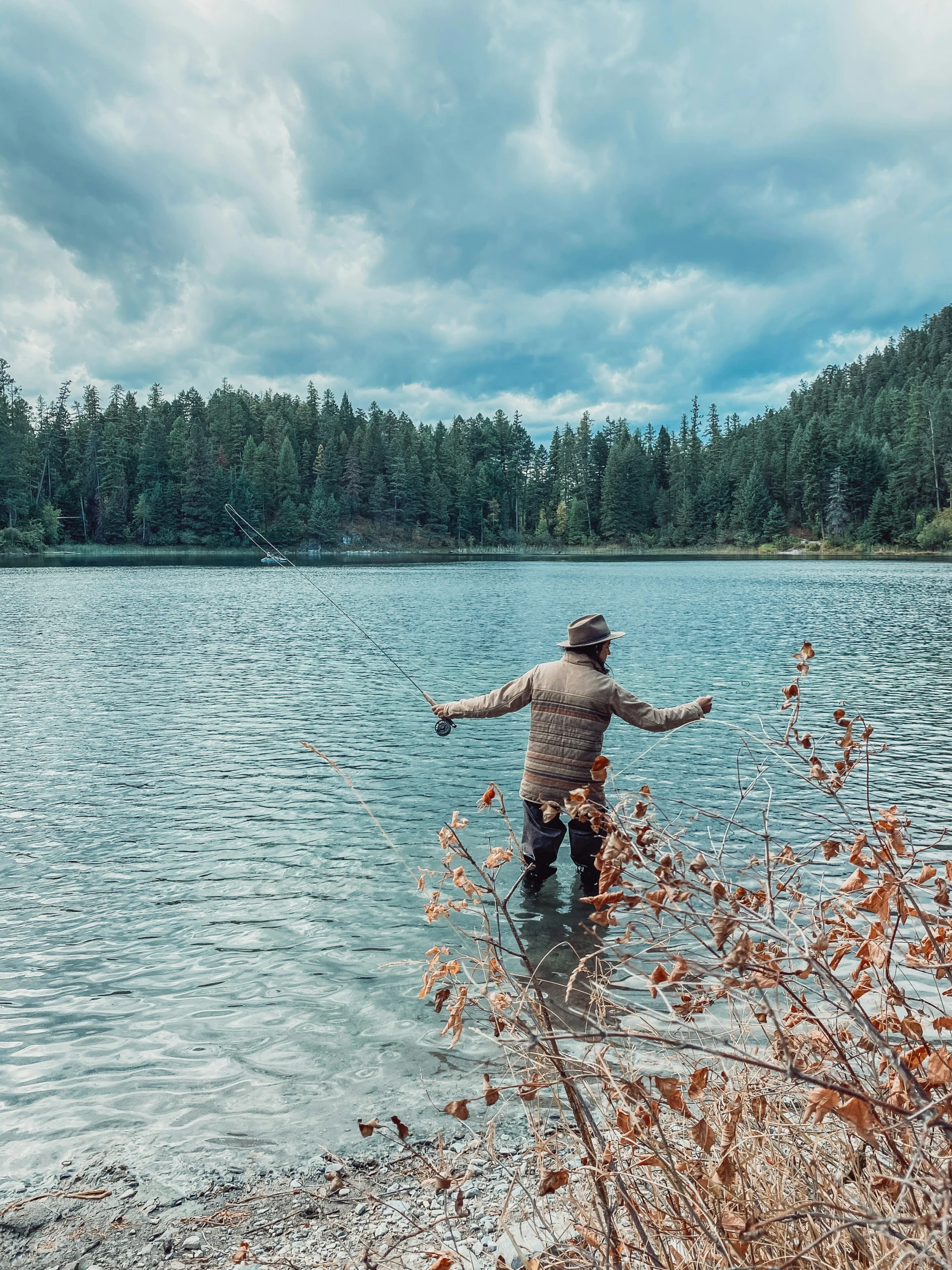 man standing in the water throwing a frisbee