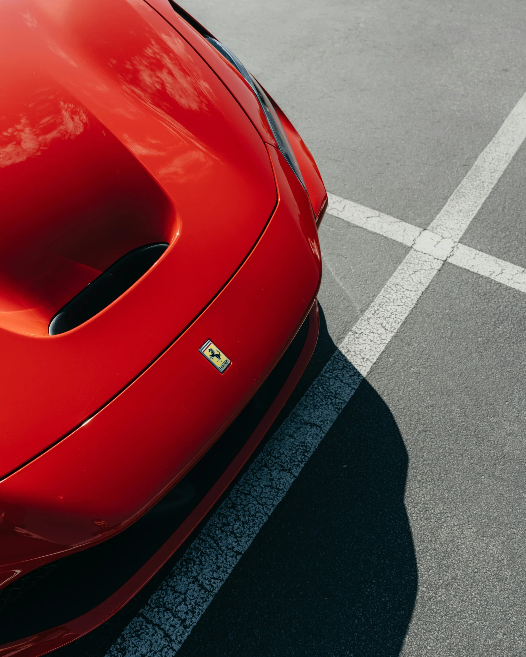 a red sports car sits parked in the street