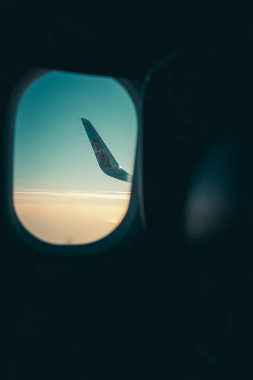 a view out an airplane window of the sky and clouds