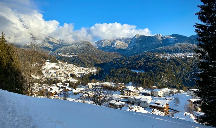 a small village below a snowy mountain range