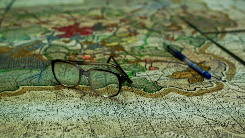 a pair of glasses are on top of a world map