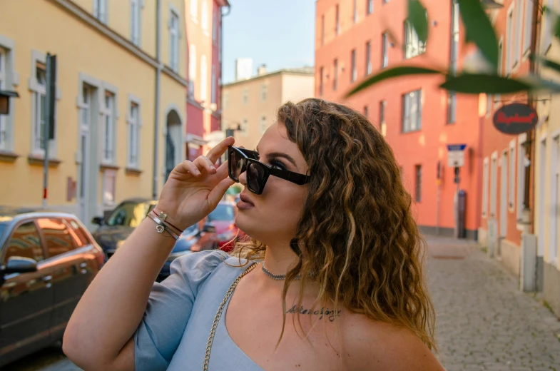 a woman is talking on the phone while walking down the street