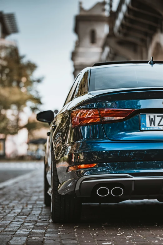 a close up of the rear end of a car parked on the side of a street