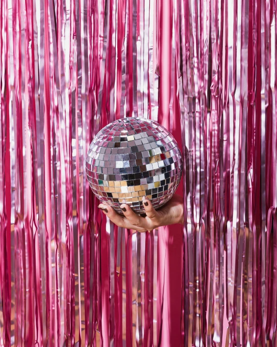 someone holding up a disco ball to the camera