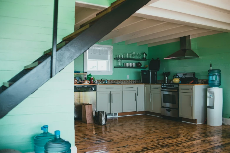 a kitchen with stainless steel appliances and wood floors