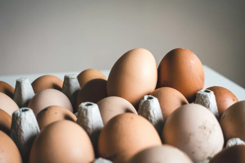 brown eggs are displayed in a box of eggs